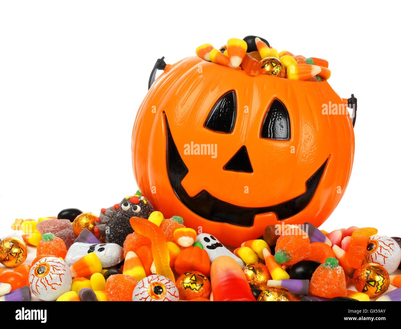 Halloween Jack o Lantern pail overflowing with candy Stock Photo Alamy