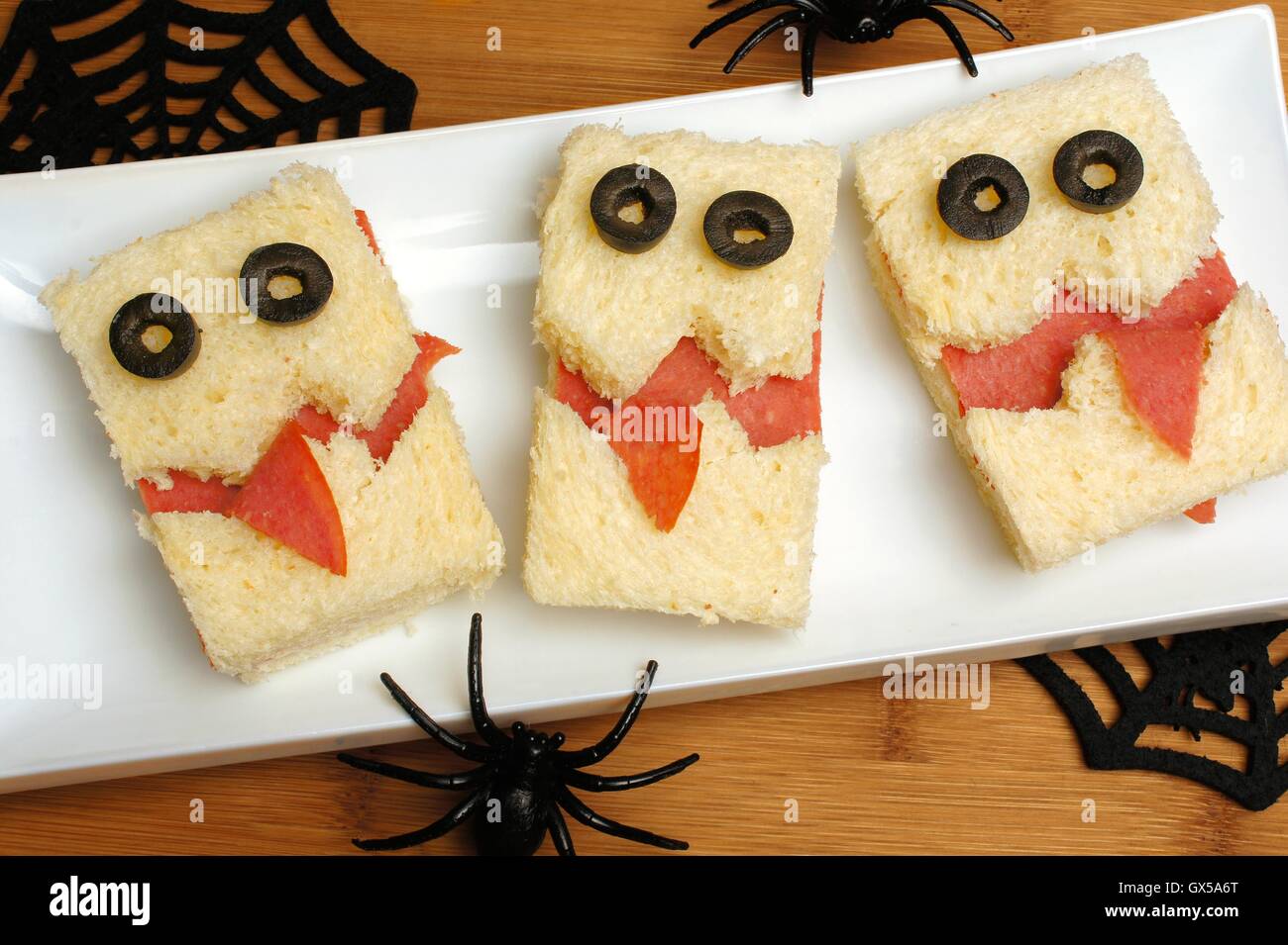Fun Halloween monster sandwiches on a plate with wood background Stock Photo