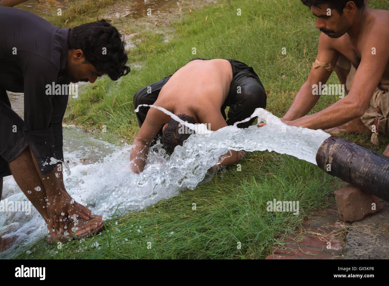 workers are bathing their bodies after hard work during hot summer ...