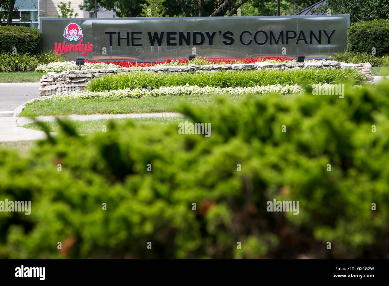 A logo sign outside of the headquarters of The Wendy's Company fast food restaurant chain in Dublin, Ohio on July 23, 2016. Stock Photo