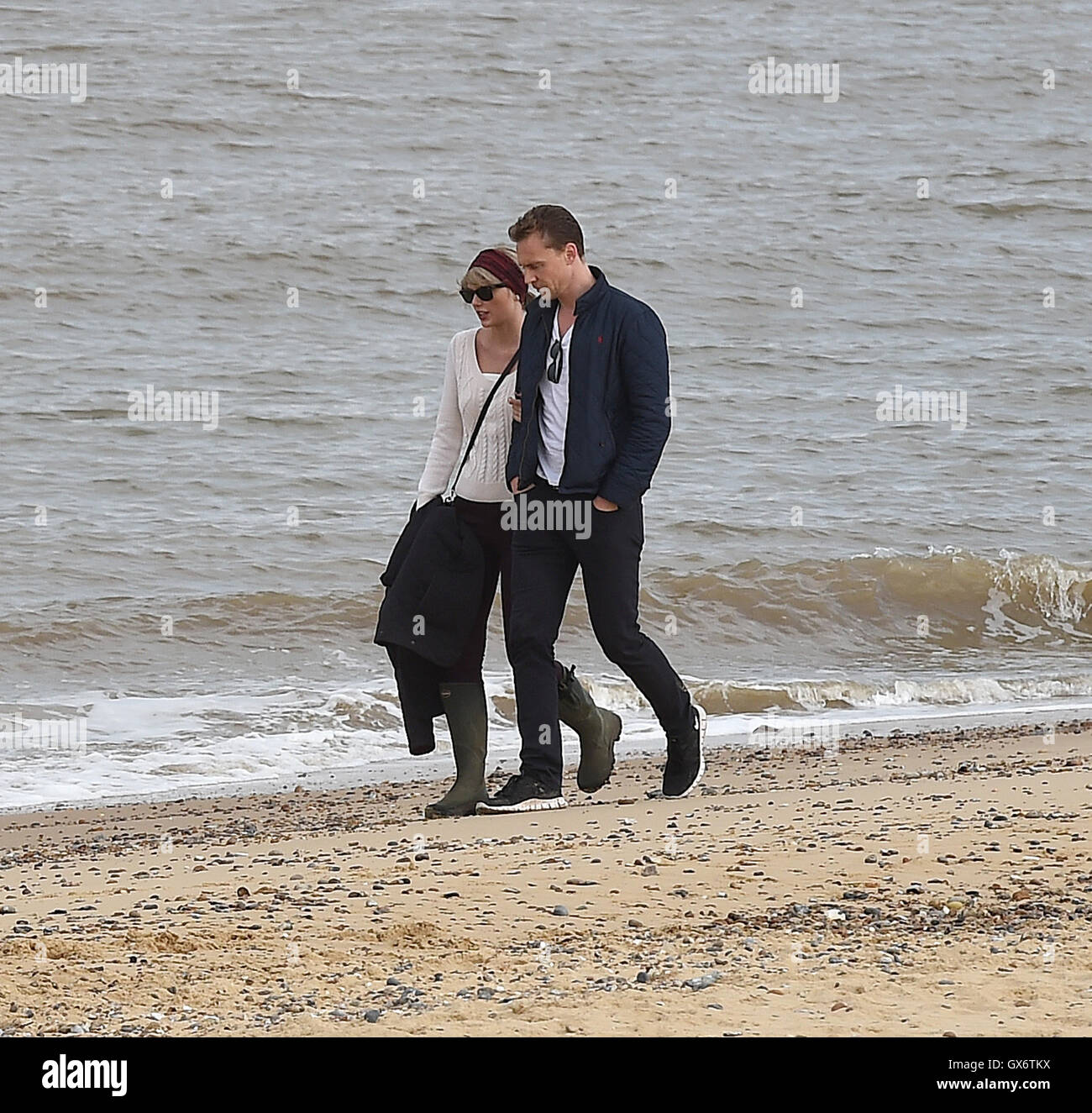 Taylor Swift and new boyfriend Tom Hiddleston enjoy a romantic walk on the  beach near Lowestoft in Suffolk, England. The couple were joined by Tom's  mother and some other friends. After 2