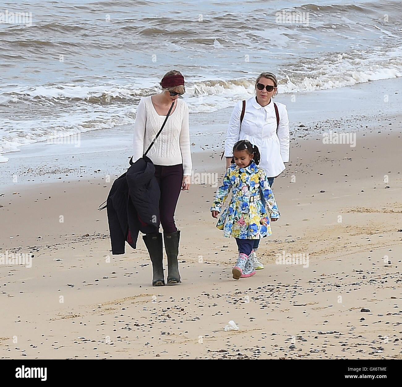 Taylor Swift and new boyfriend Tom Hiddleston enjoy a romantic walk on the  beach near Lowestoft in Suffolk, England. The couple were joined by Tom's  mother and some other friends. After 2