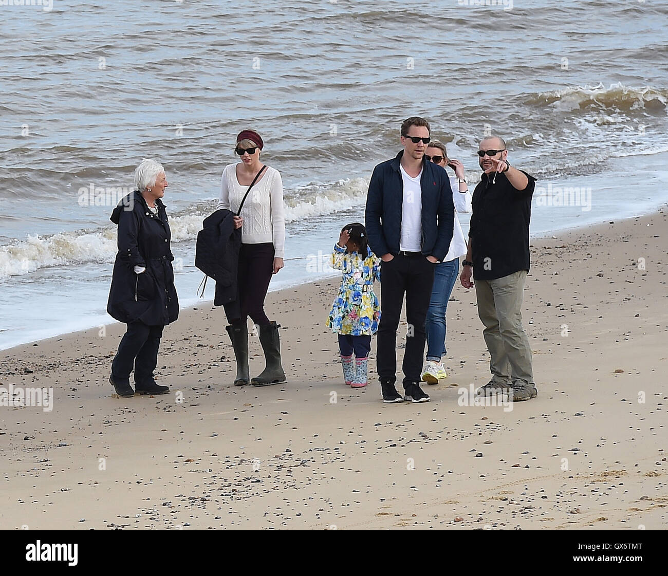 Taylor Swift and new boyfriend Tom Hiddleston enjoy a romantic walk on the  beach near Lowestoft in Suffolk, England. The couple were joined by Tom's  mother and some other friends. After 2