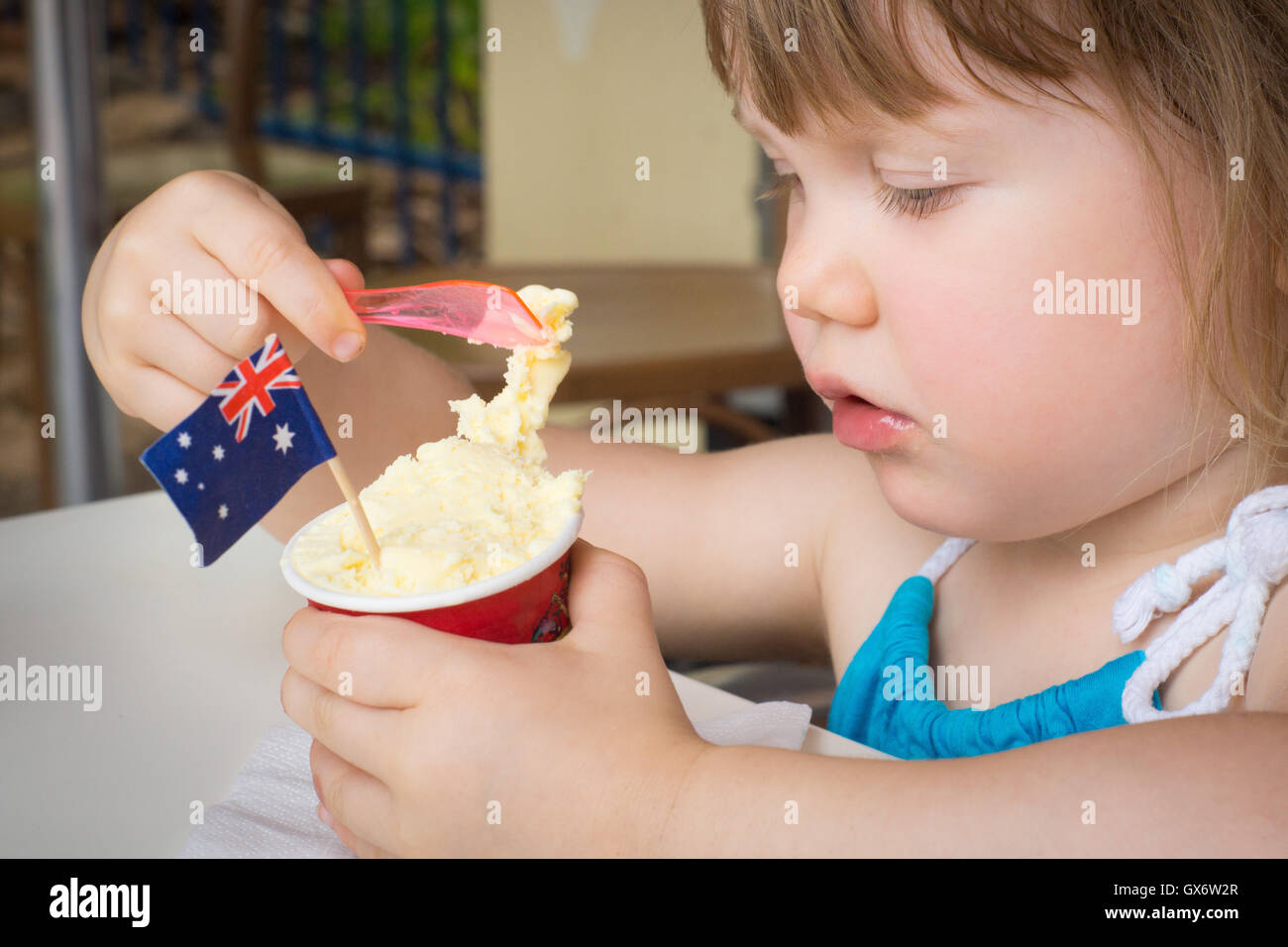 Young girl eating ice cream on Australia Day with Australian flag Stock Photo