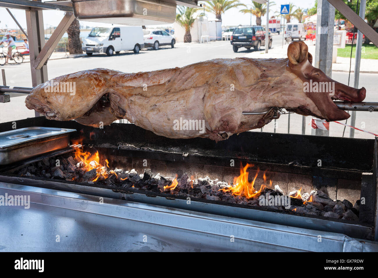 Pig roasting over charcoal flames Stock Photo Alamy
