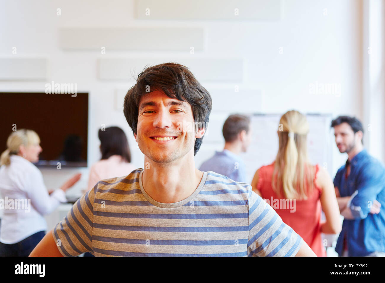 Businessman from start-up smiling proud of his team Stock Photo - Alamy