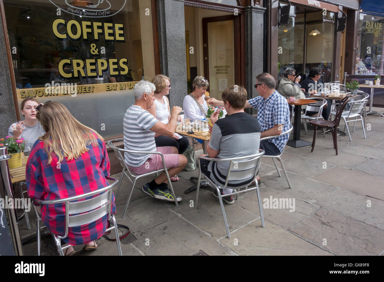 Street café culture people eating drinking resting Kings Parade Cambridge City Cambridgeshire England 2016 Stock Photo