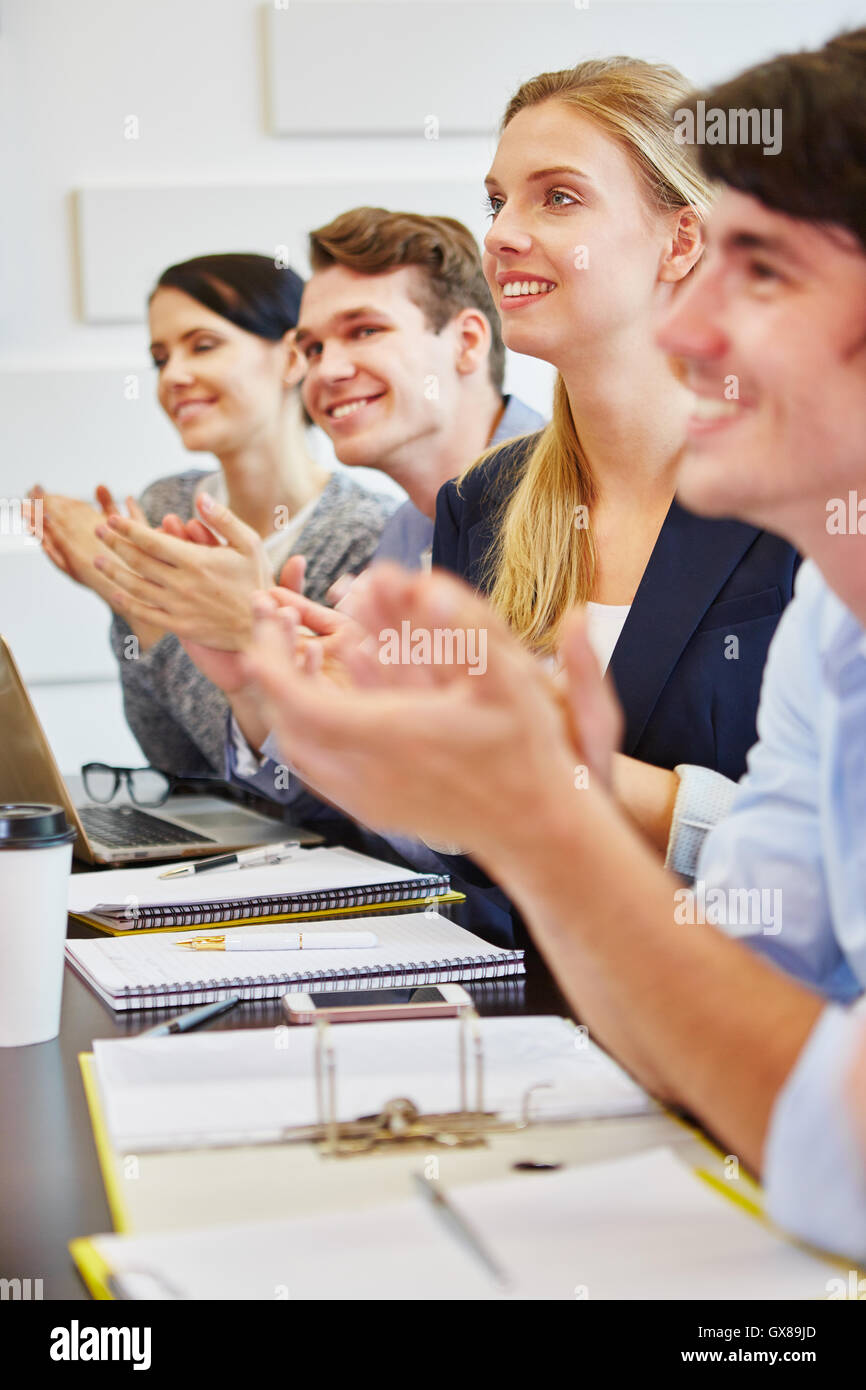 Young business people clapping hands in startup seminar Stock Photo