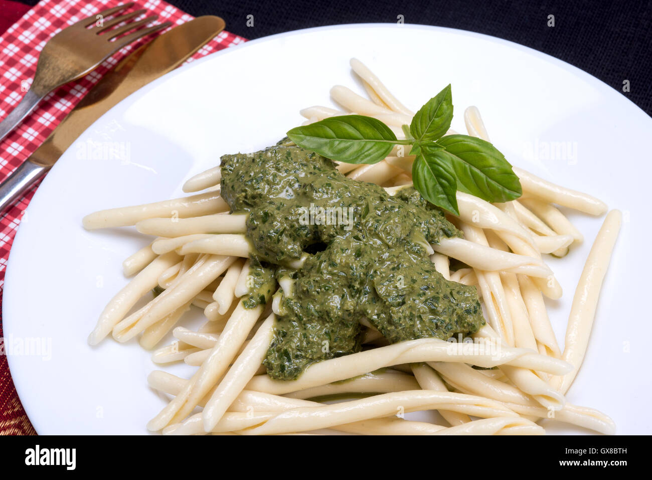 Traditional Italian pasta originating from region Liguria served with pesto sauce Stock Photo