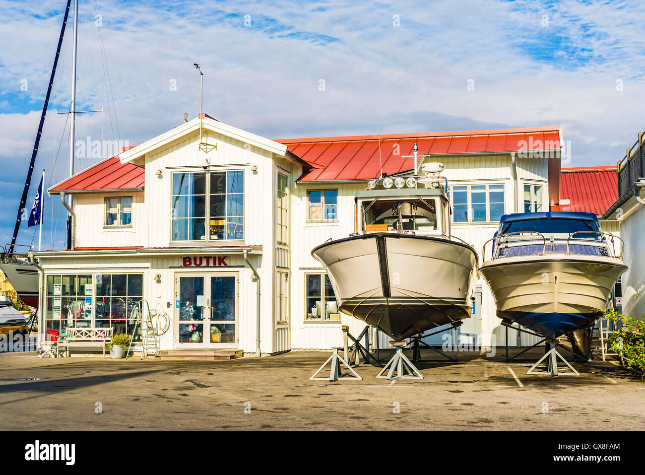 Marstrand, Sweden - September 8, 2016: Environmental documentary of the area surrounding the shipyard shop Butik with two motorb Stock Photo