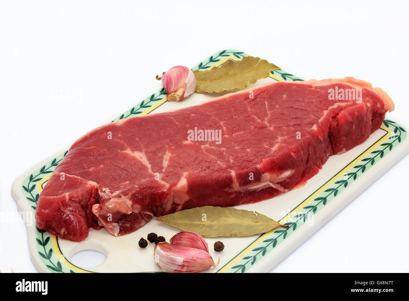Sirloin steak on a ceramic board. Stock Photo