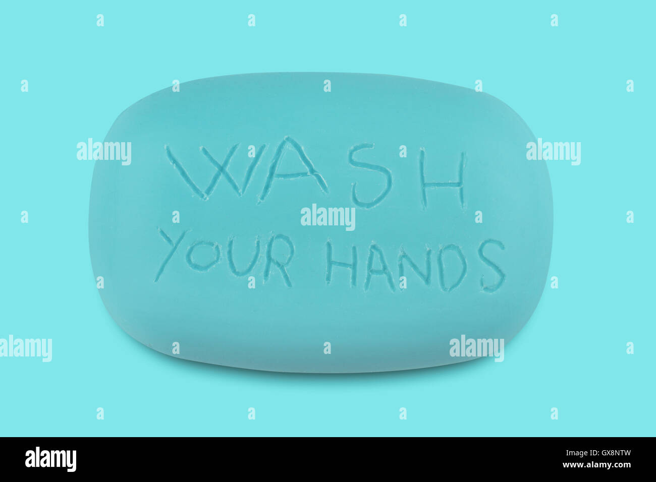 Top view of a blue soap bar with the words wash your hands scratched on it Stock Photo