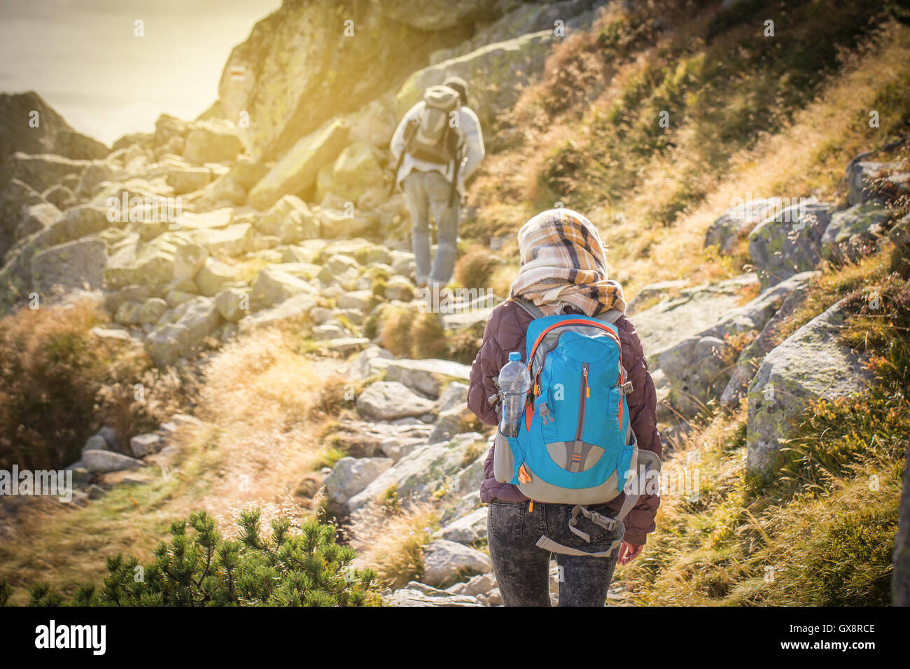 tourists trekking in high mountains in sunset Stock Photo