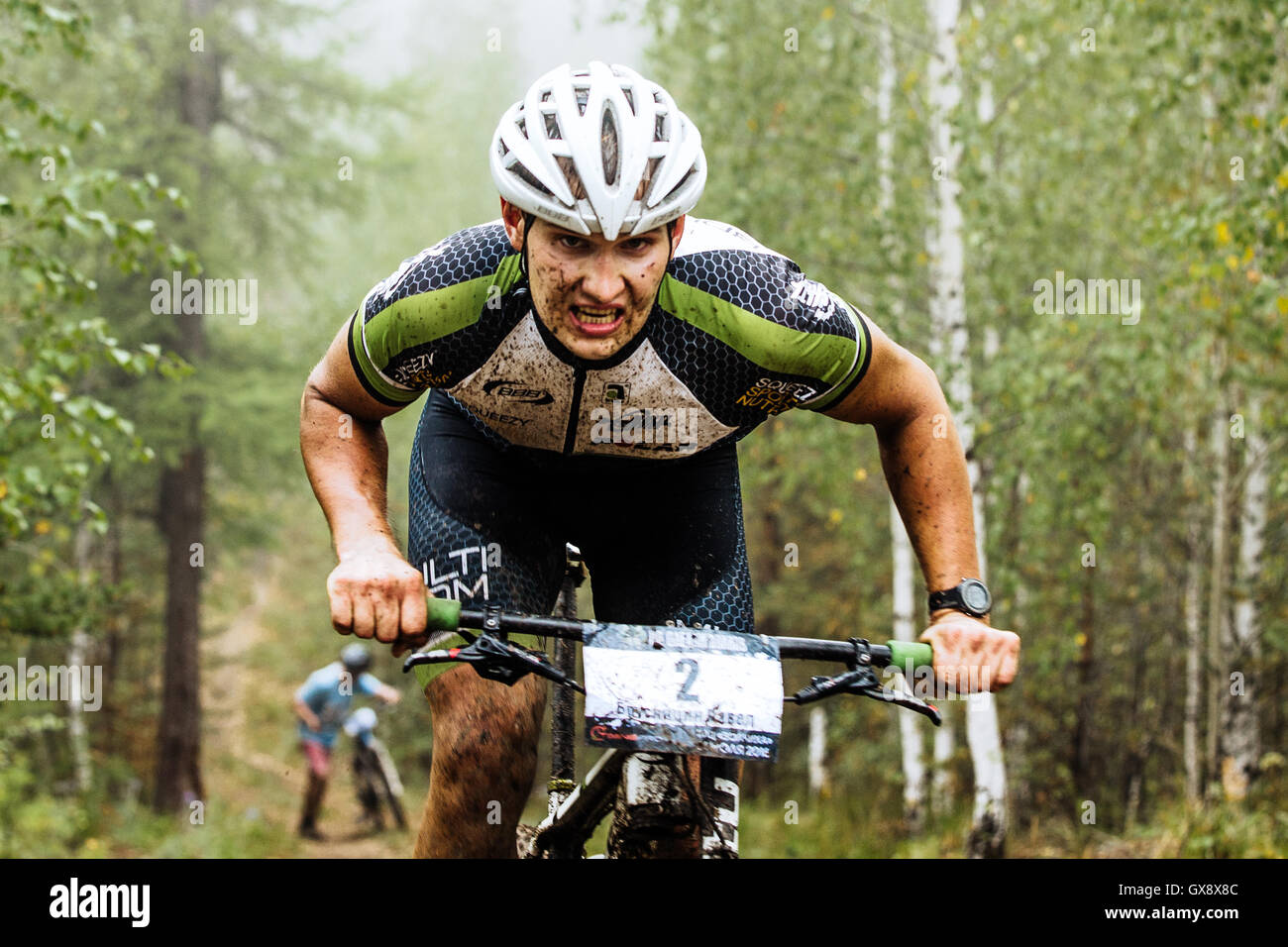 closeup of a male cyclist rides through forest, he has a dirty face during  Regional competitions on cross-country bike Stock Photo - Alamy