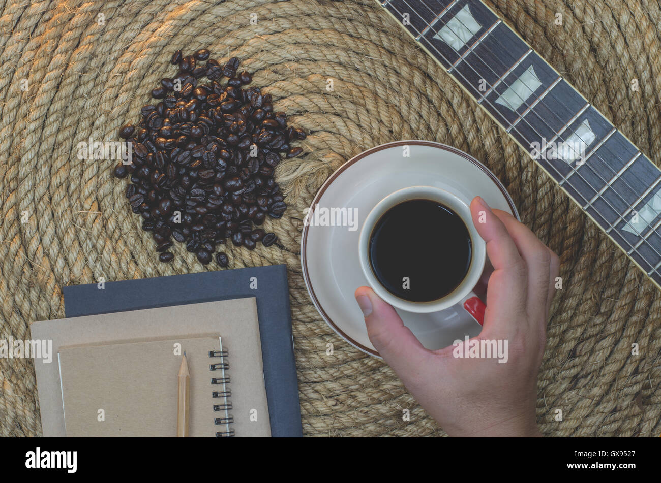 Cup of coffee with  notebook on a jute rope. Stock Photo