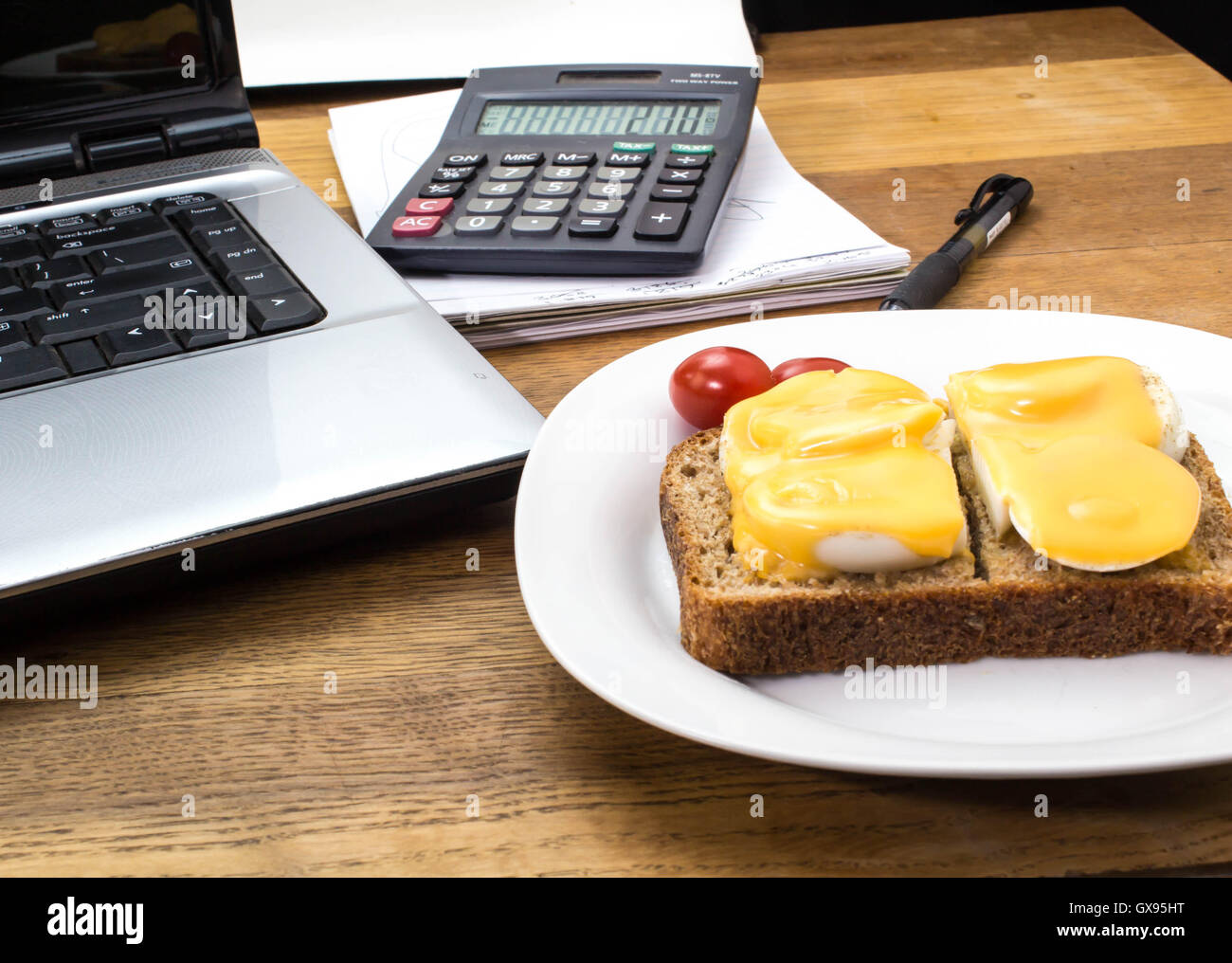 Egg and melted cheese on bread snack at office computer Stock Photo - Alamy