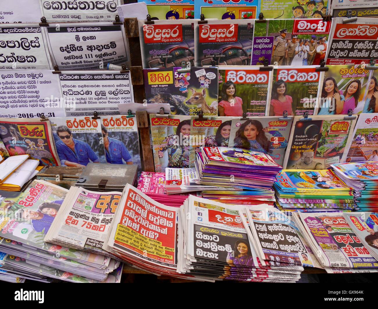 Newsstand display of large selection of newspapers and magazines in