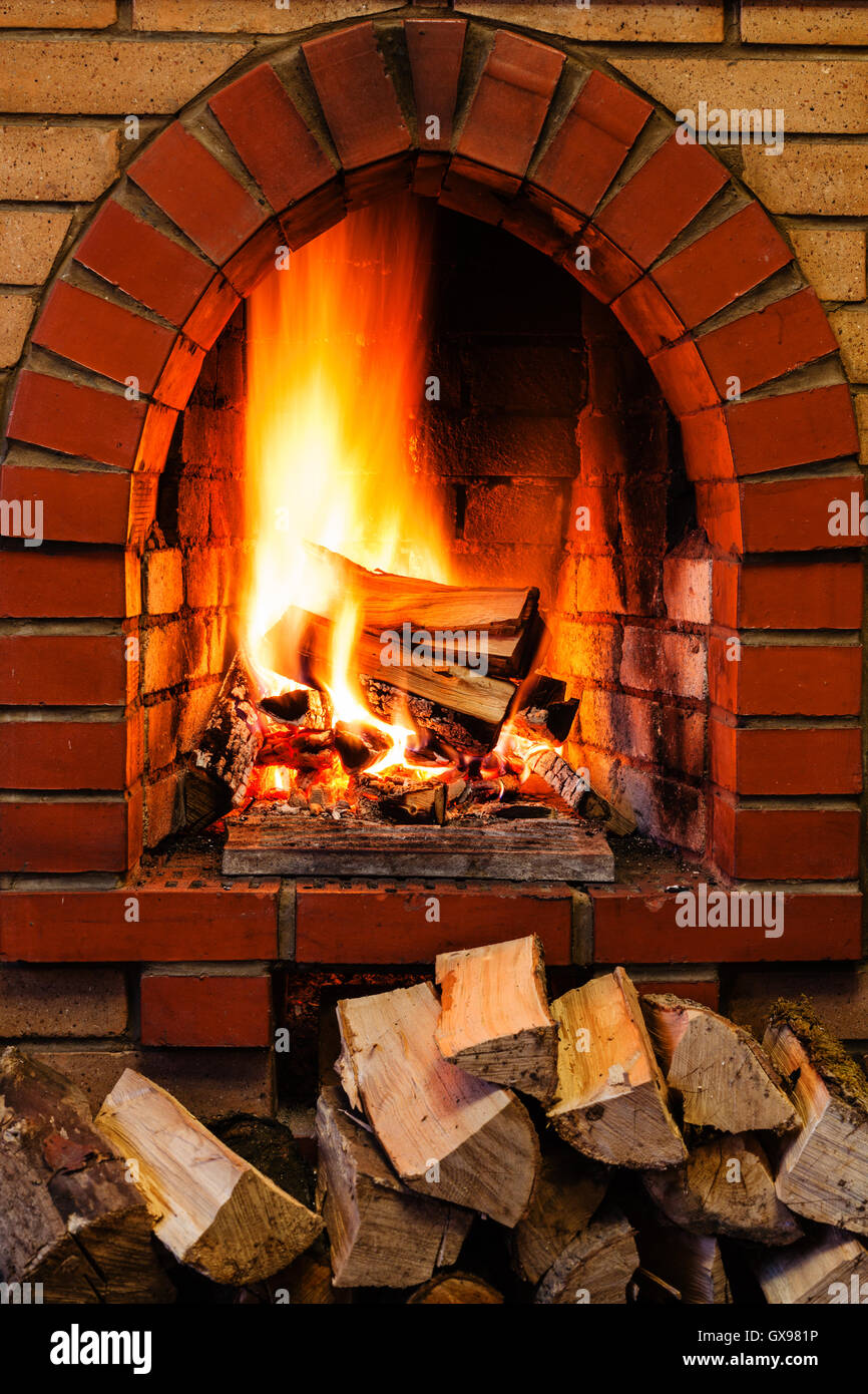 Pile firewood burning in fireplace hi-res stock photography and images ...