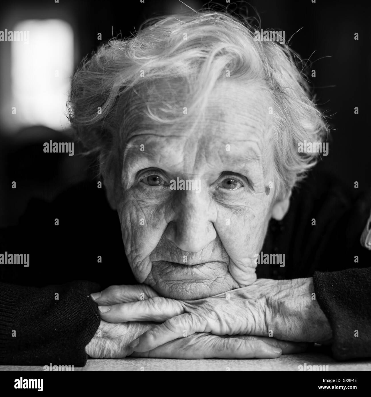 Photo by Linda M, - Black and white portrait of a smiling elderly woman  with gray hair in a floral dress