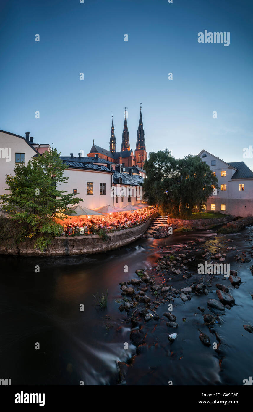 Night at the old mill at Kvarnfallet in the Fyris river with the Cathedral (Domkyrkan) in the background, Uppsala, Sweden Stock Photo
