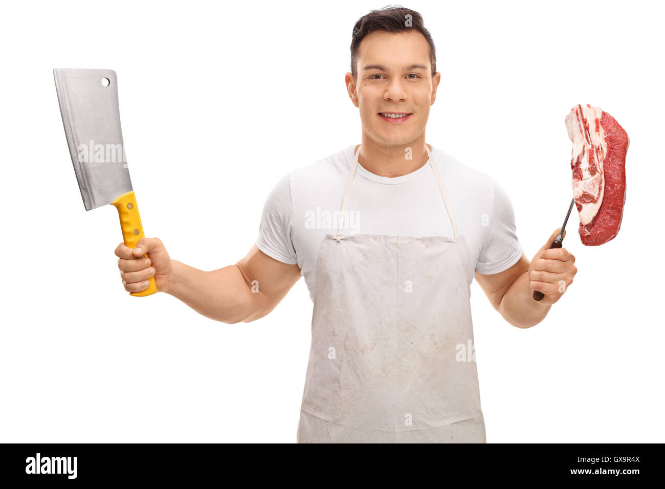 Young butcher holding a cleaver and a fork with a steak isolated on