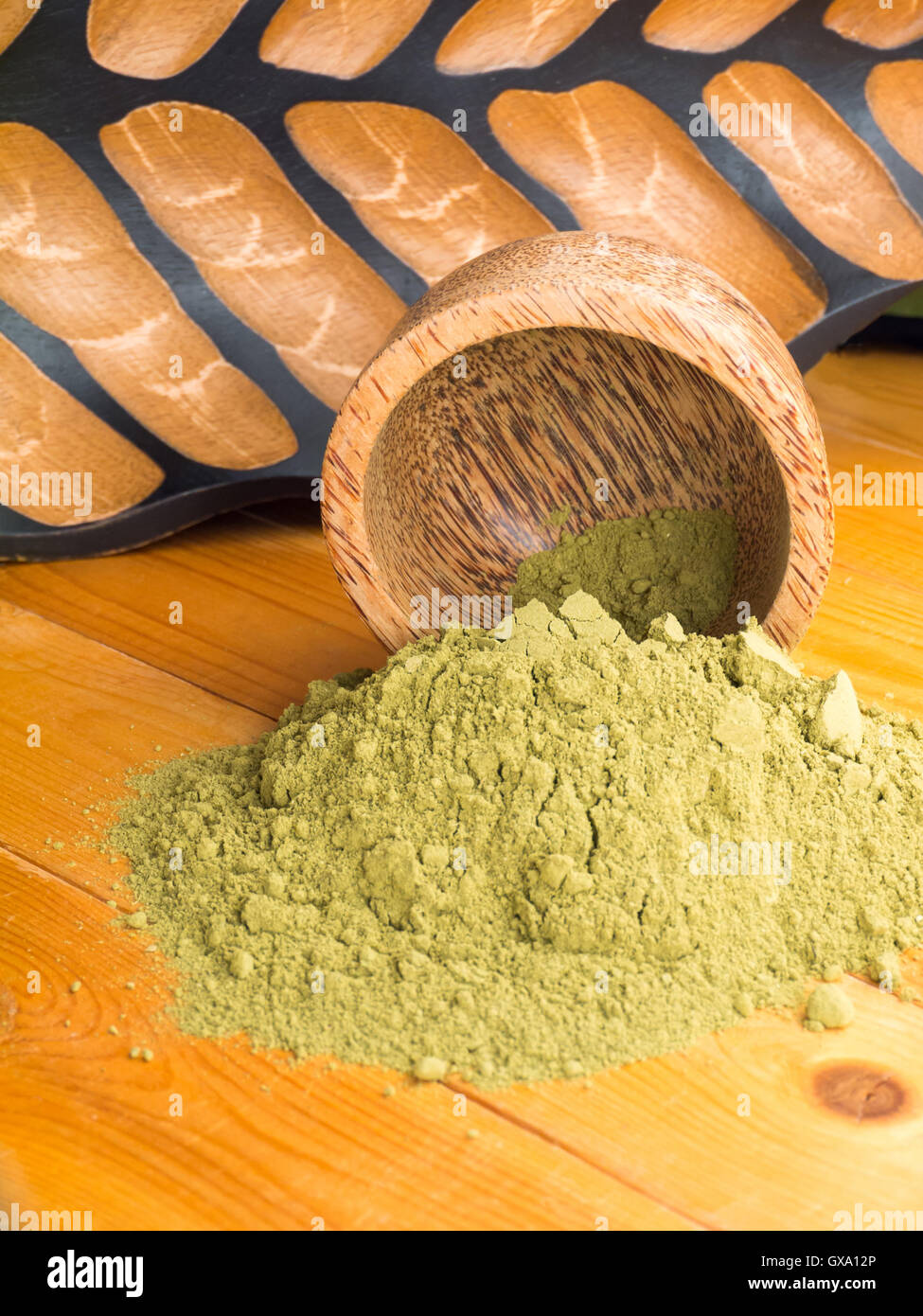 Henna powder hair colourant in the coconut bowl on textured wooden background Stock Photo