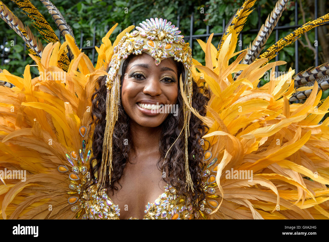 Portrait of a dancer wearing yellow feather costume during the 50th Notting Hill Carnival celebrations Stock Photo Alamy