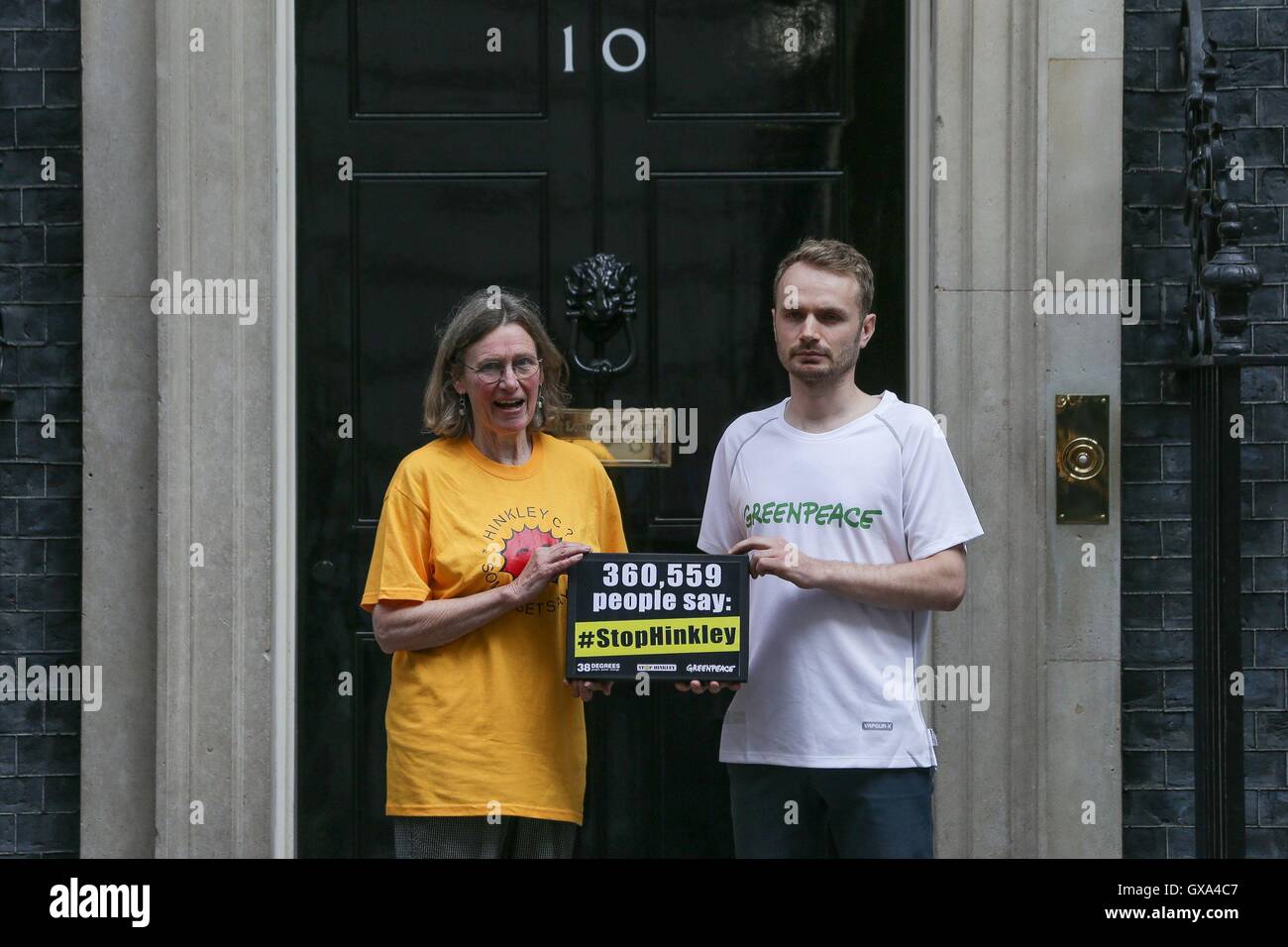 Stop Hinkley campaigner Sue Aubrey and Richard Casson (right) from Greenpeace UK hand a petition to Downing Street in London, calling on Prime Minister Theresa May to drop Hinkley and invest in renewable power instead. Stock Photo