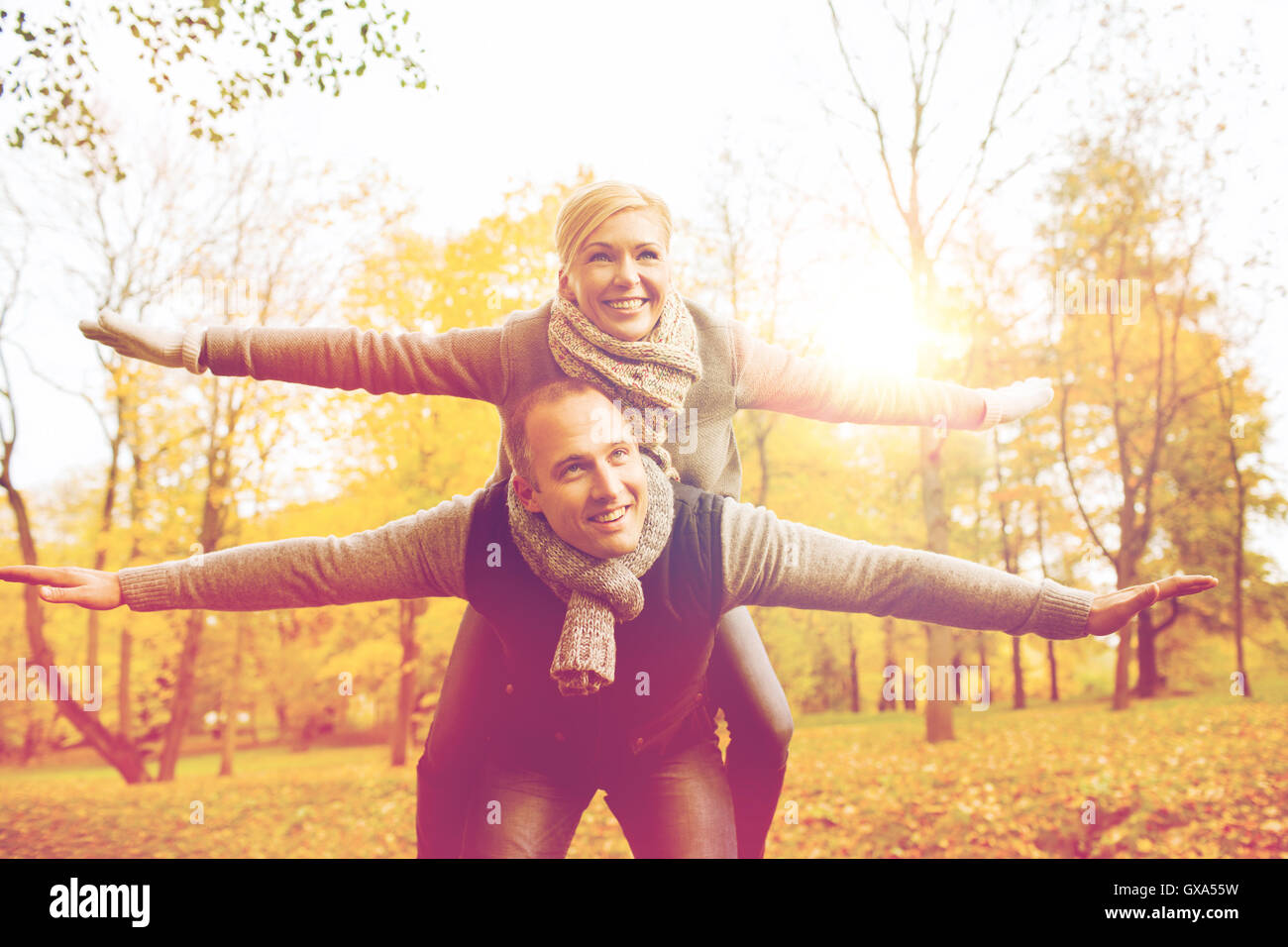 smiling couple having fun in autumn park Stock Photo - Alamy