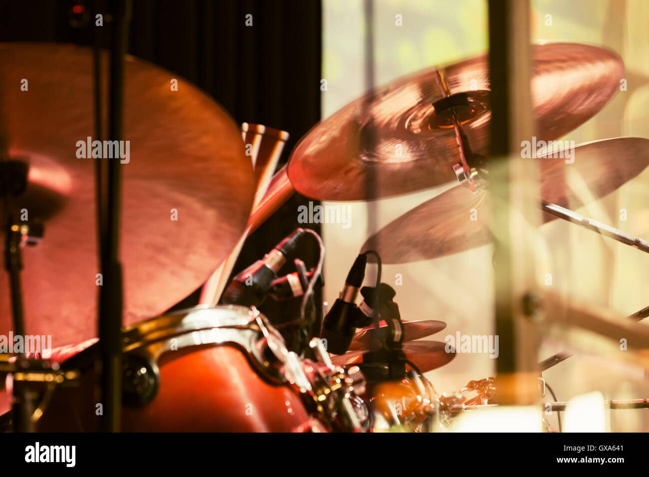 Vintage toned rock music blurred photo background, drummer plays on cymbals, old instagram style Stock Photo