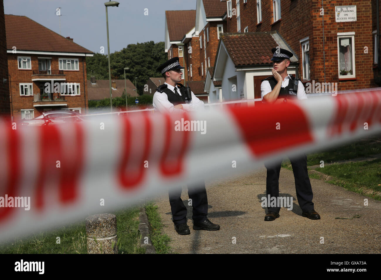 Police officers utside flats in in Elmshurst Crescent in East Finchley, north London where Anny Ekofo, 52, and her nephew Bevely, 21, where found dead with gunshot wounds. Stock Photo