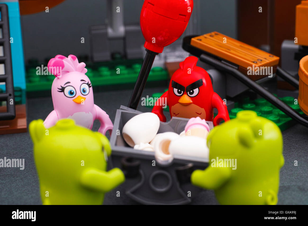 Lego Angry Birds. Red, Stella and 2 bad piggies standing near bin with eggs and ice cream in Pig City. Stock Photo