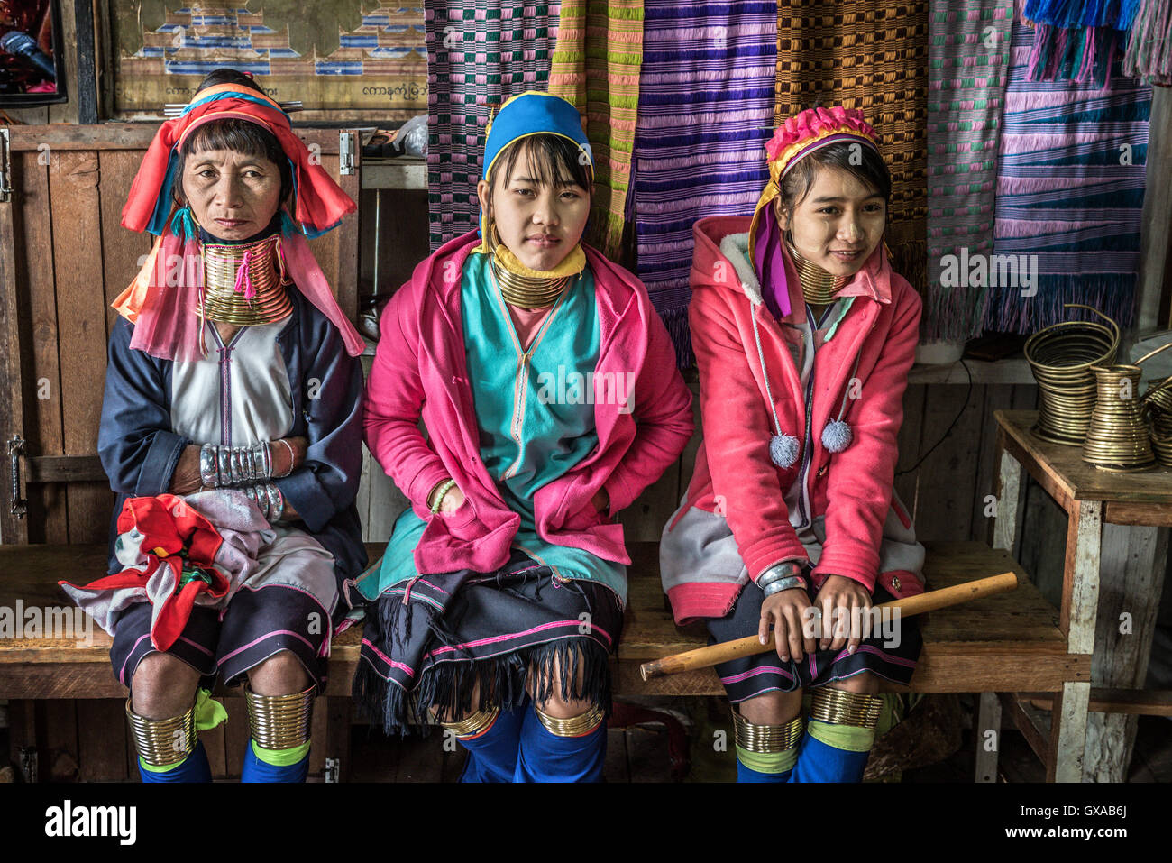 Three women of the Kayan Lahwi tribe wearing traditional metal rings on their necks Stock Photo