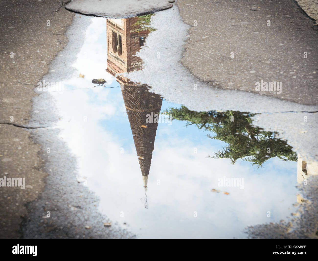 Reflection of tower on water puddle Stock Photo - Alamy
