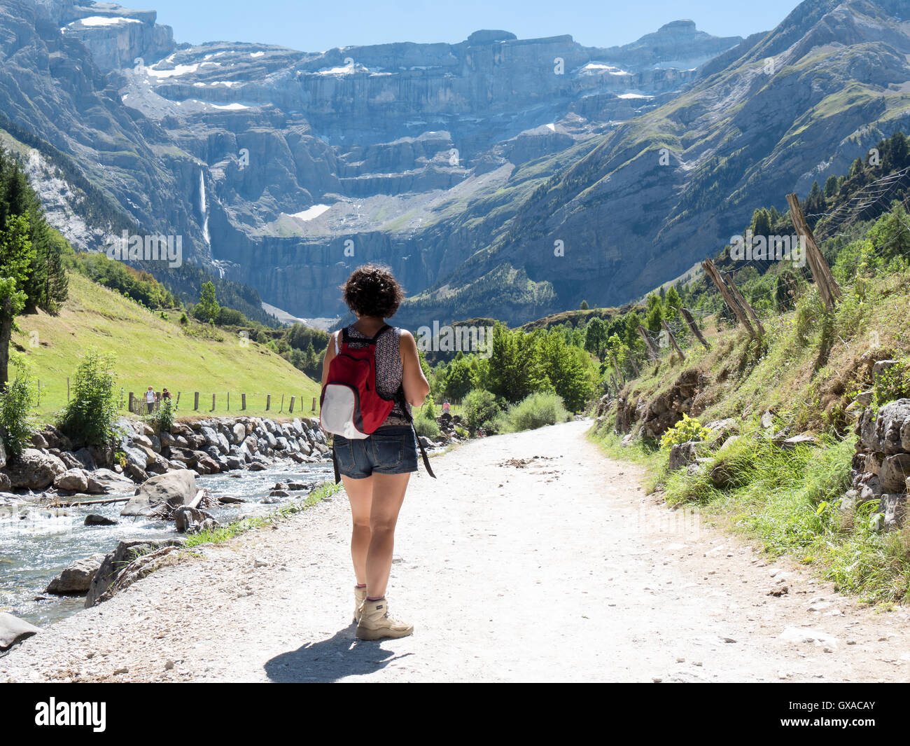 A woman hiker and cirque de Gavarnie in the French pyrenees mountains ...
