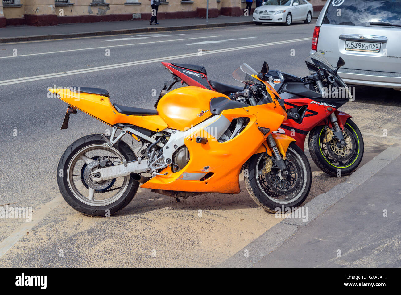 Moscow, Russia - July 14, 2016: Two brightly colored motorcycle parked on an asphalt road near the sidewalk on a city street Stock Photo