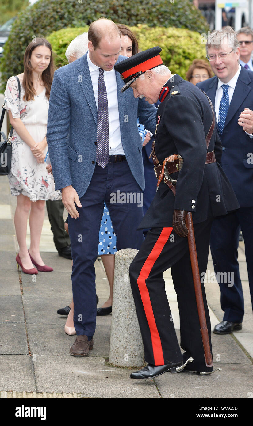 The Duke of Cambridge comes to the aid of Jonathan Douglas-Hughes, Vice Lord-Lieutenant of Essex when he took a tumble as he arrived at Stewards Academy in Harlow, Essex, where he and his wife the Duchess of Cambridge are promoting their Heads Together campaign, are finding out how young people are coping with life's pressures. Stock Photo