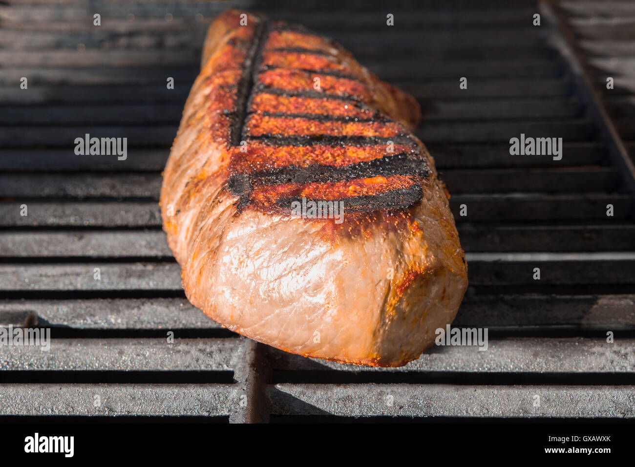 London Broil cut of beef steak on barbecue grill cooking Stock Photo