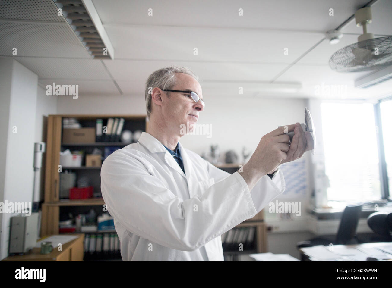 Meteorologists Male Male meteorologist examining equipment in weather station laboratory ...