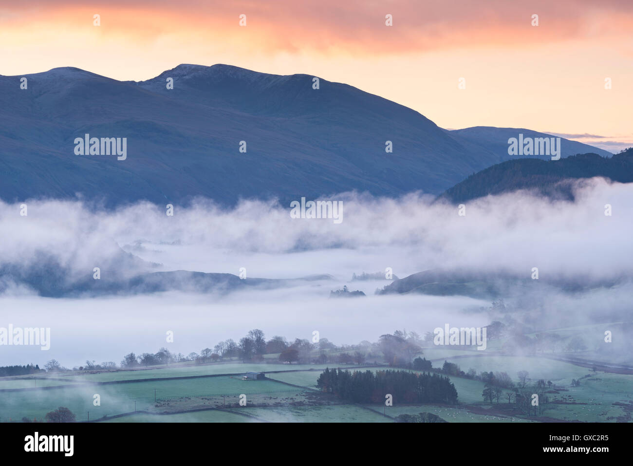 Mist covered landscape of the Lake District at dawn, Cumbria, England. Autumn (November) 2014. Stock Photo