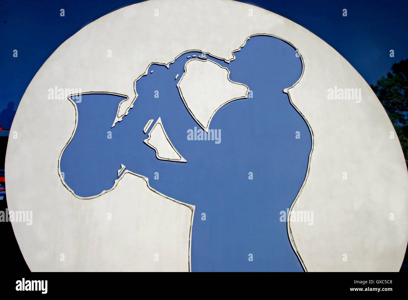 A silhouette of a man playing a saxophone Stock Photo