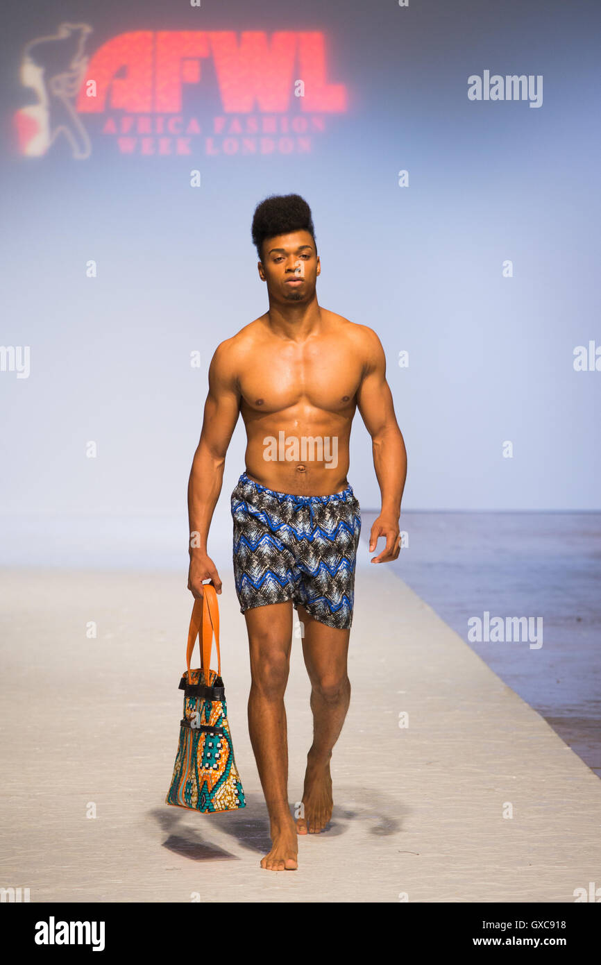 Meme Bete is showcased at the Africa Fashion Week London. Model walks the runway carrying a bag and wearing a swimsuit. Stock Photo