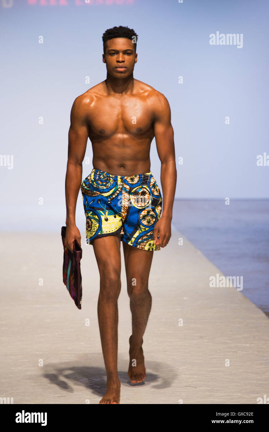 Meme Bete is showcased at the Africa Fashion Week London. Model walks the runway carrying a bag and wearing a swimsuit. Stock Photo