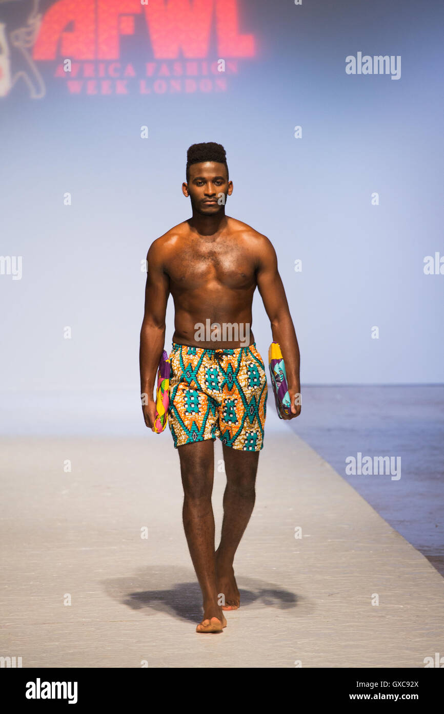 Meme Bete is showcased at the Africa Fashion Week London. Model walks the runway carrying bags and wearing a swimsuit. Stock Photo