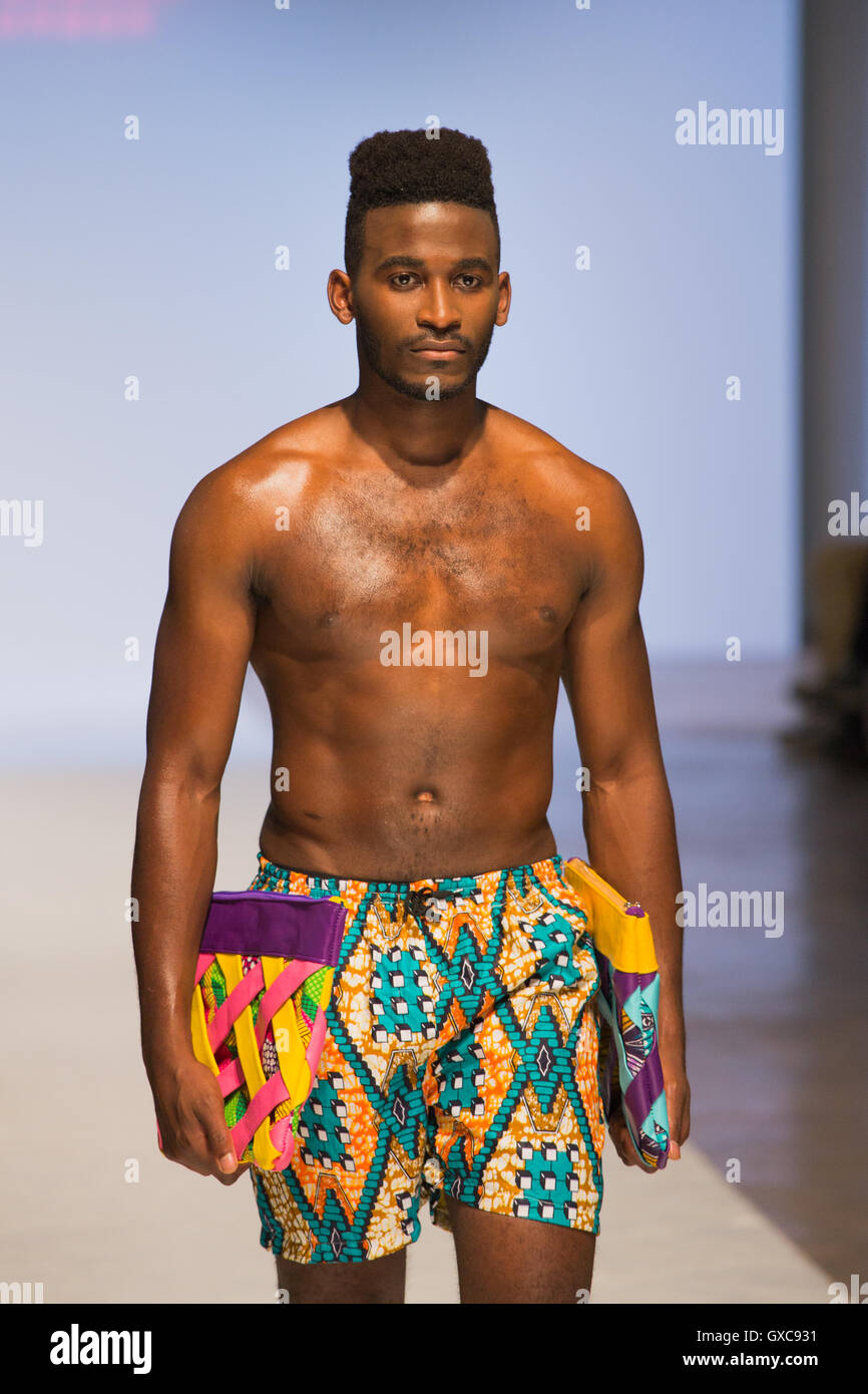 Meme Bete is showcased at the Africa Fashion Week London. Model walks the runway carrying bags and wearing a swimsuit. Stock Photo