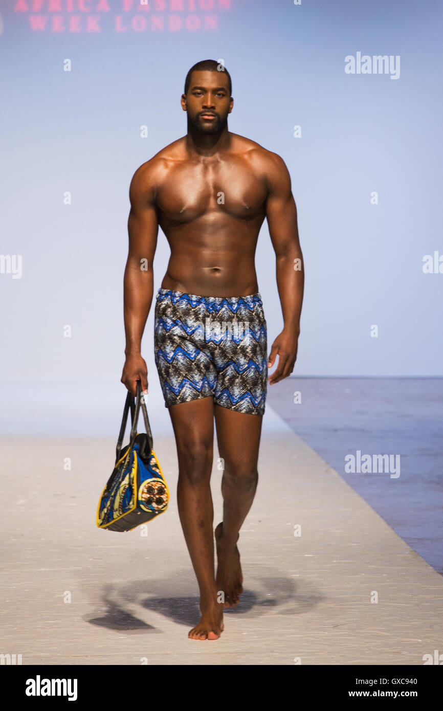 Meme Bete is showcased at the Africa Fashion Week London. Model walks the runway carrying a bag and wearing a swimsuit Stock Photo