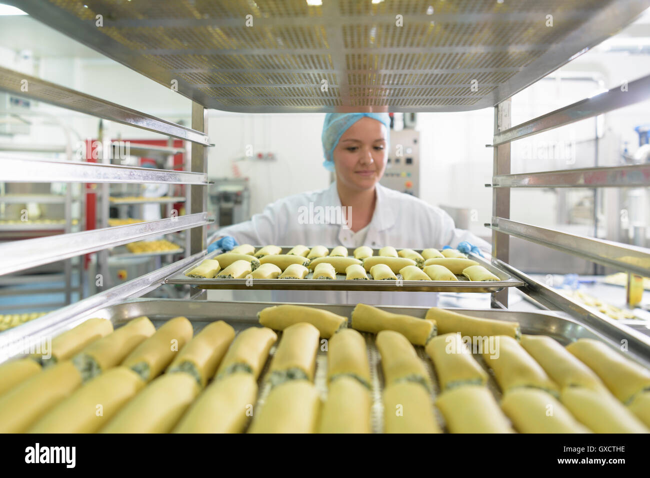 Worker hand making cannelloni pasta in pasta factory Stock Photo