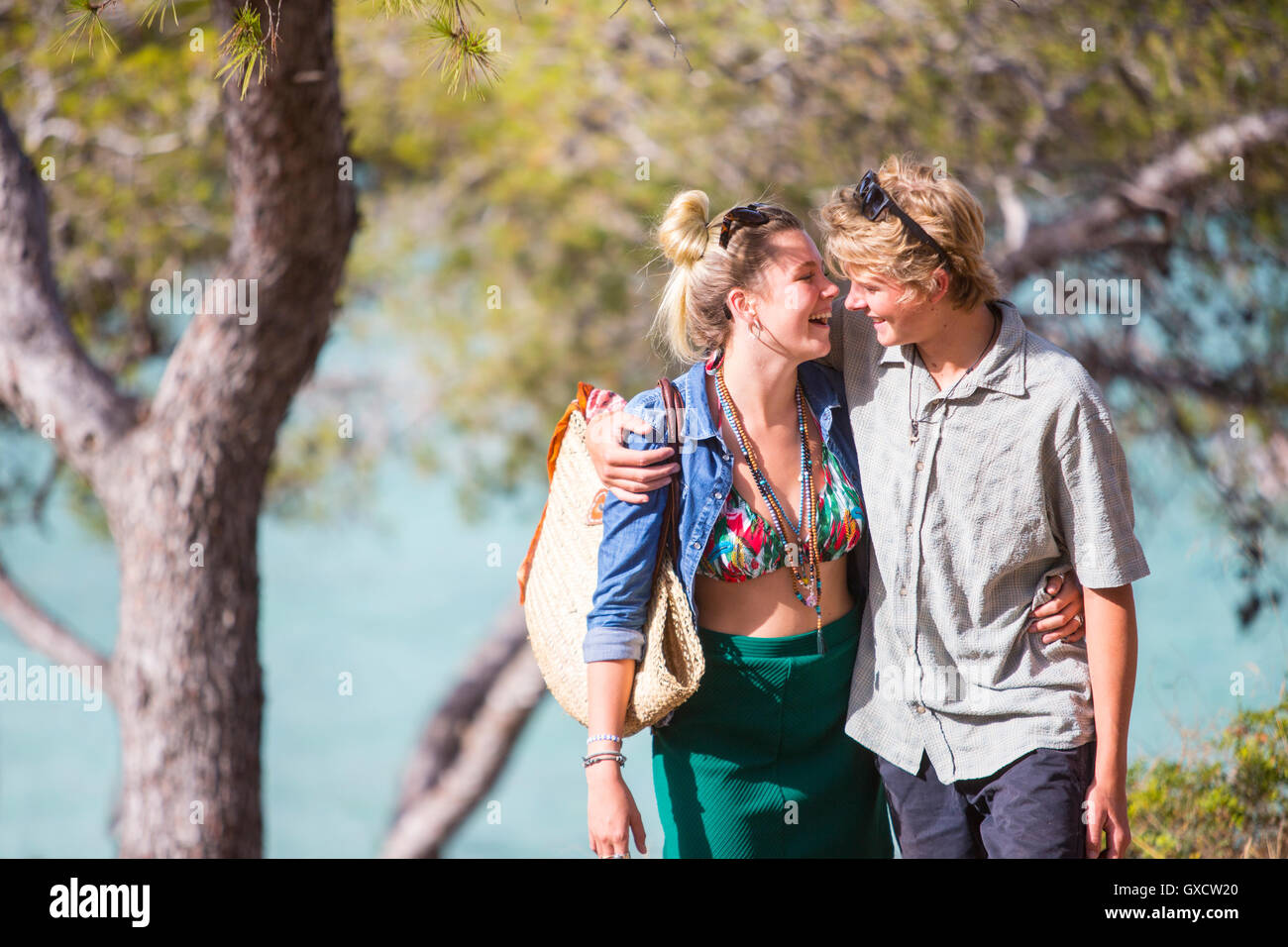 Couple with arms around each other, face to face smiling, Majorca, Spain Stock Photo