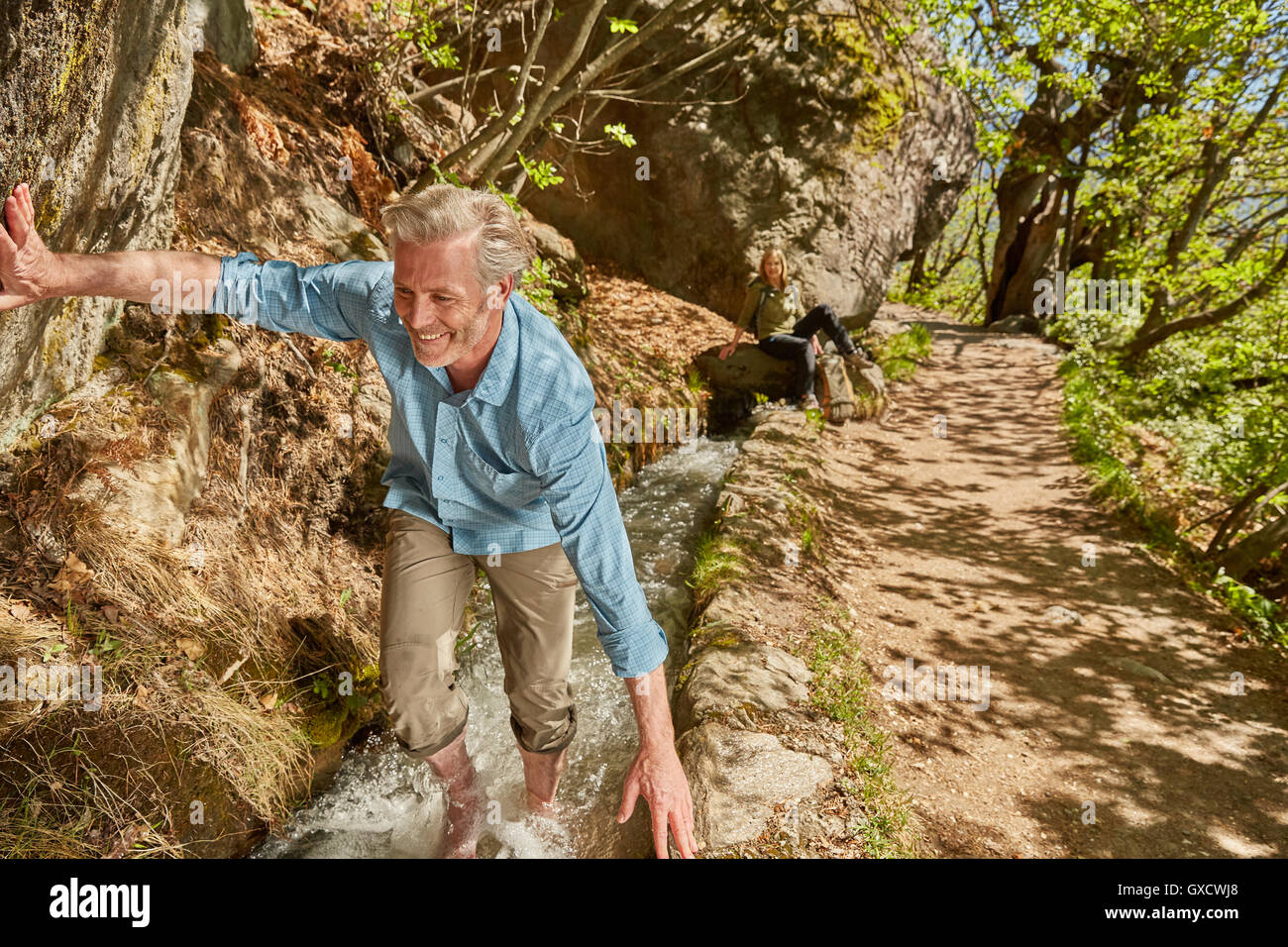 Mature man hiking up stream, Meran, South Tyrol, Italy Stock Photo