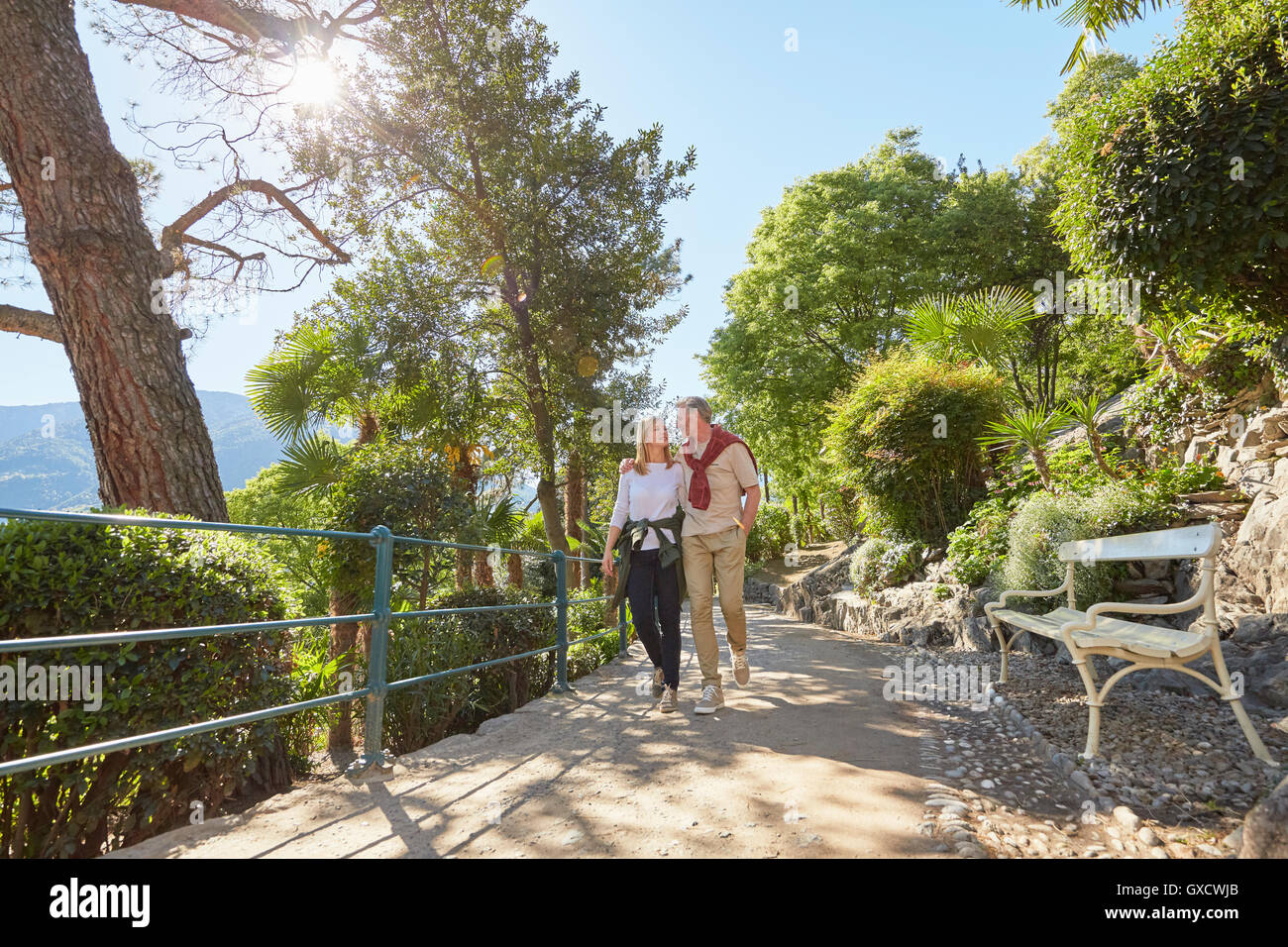 Mature couple hiking along country road, Meran, South Tyrol, Italy Stock Photo